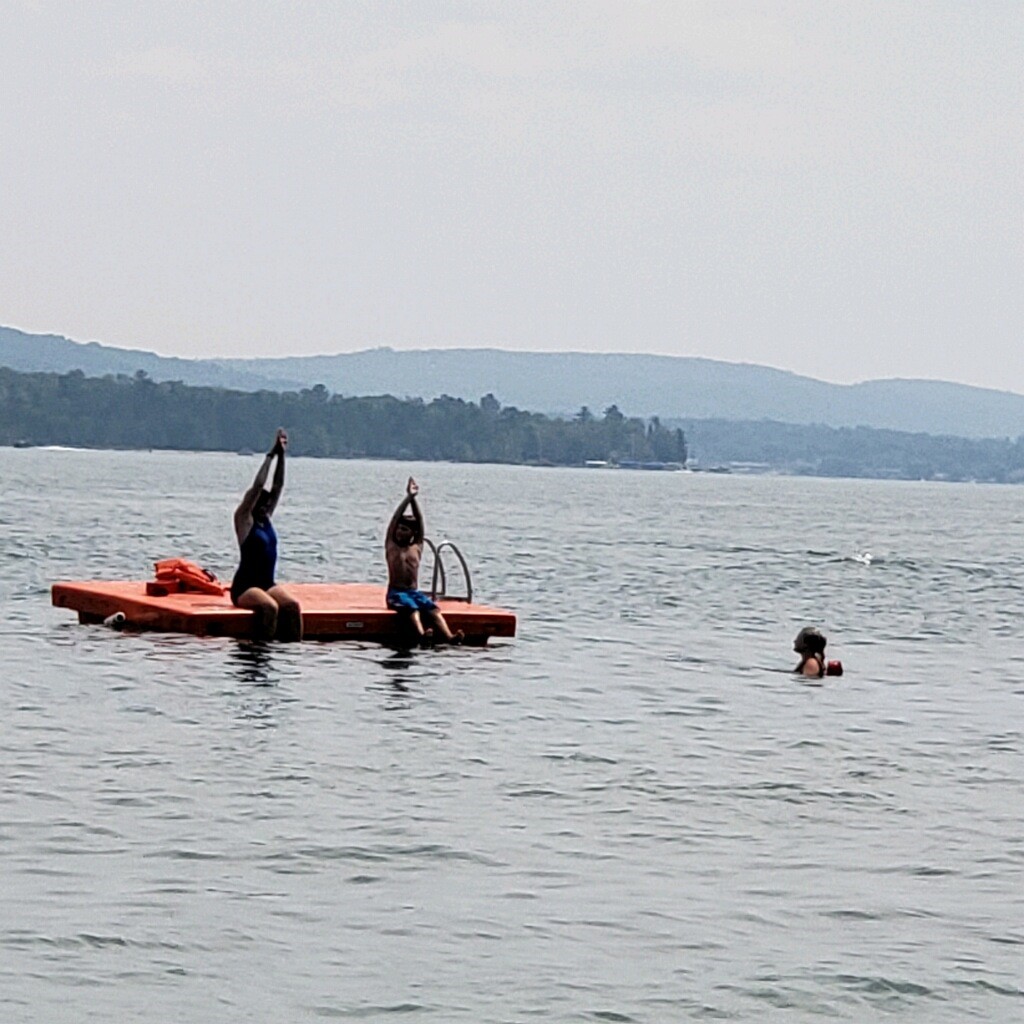 Life guard instructing a swimmer on a raft