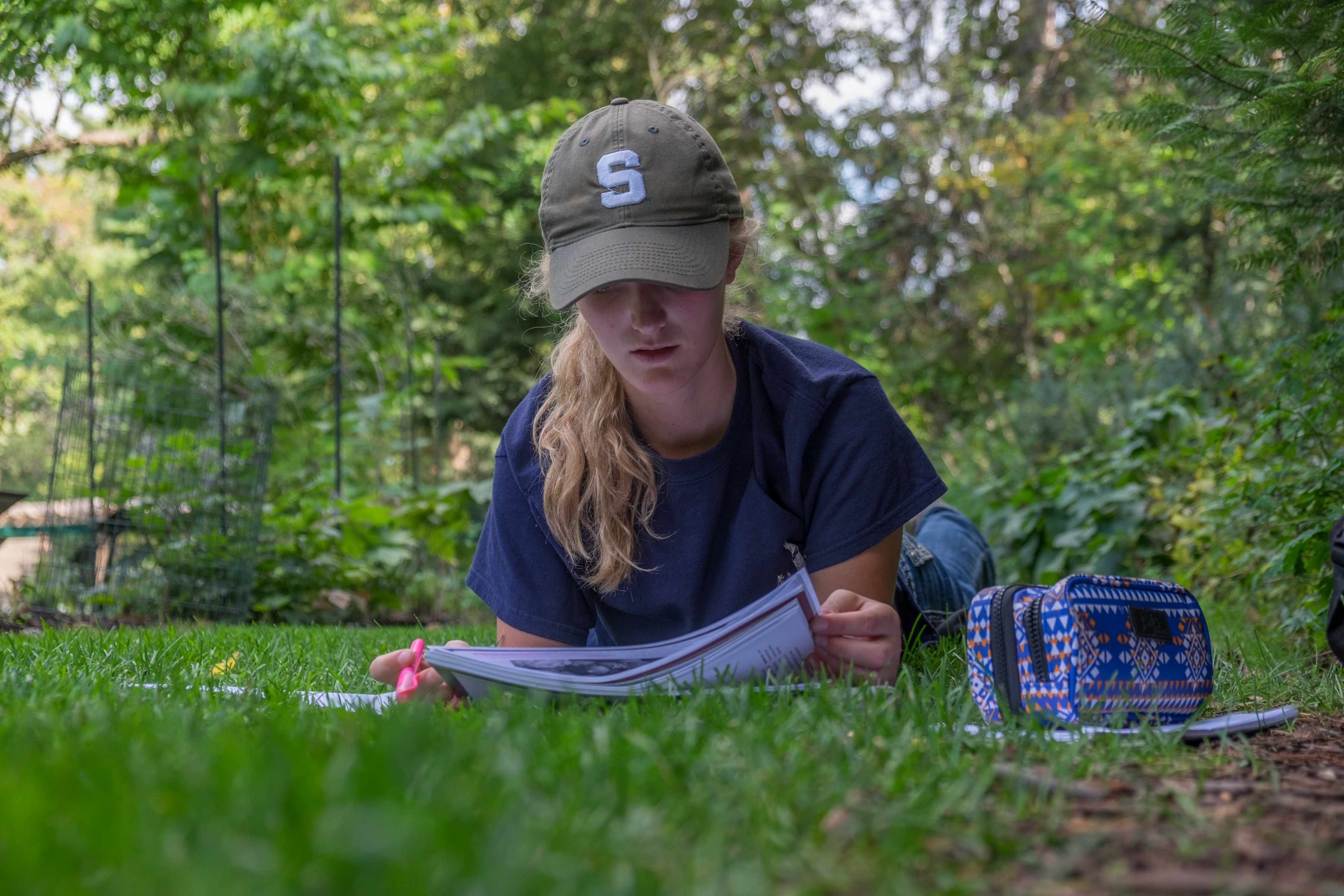 An MSU student studing in Beal Gardens on campus.