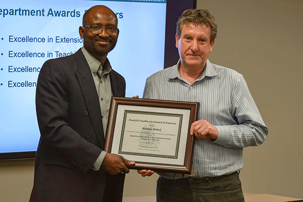 Matt Birbeck with AFRE Chair Titus Awokuse receiving his award