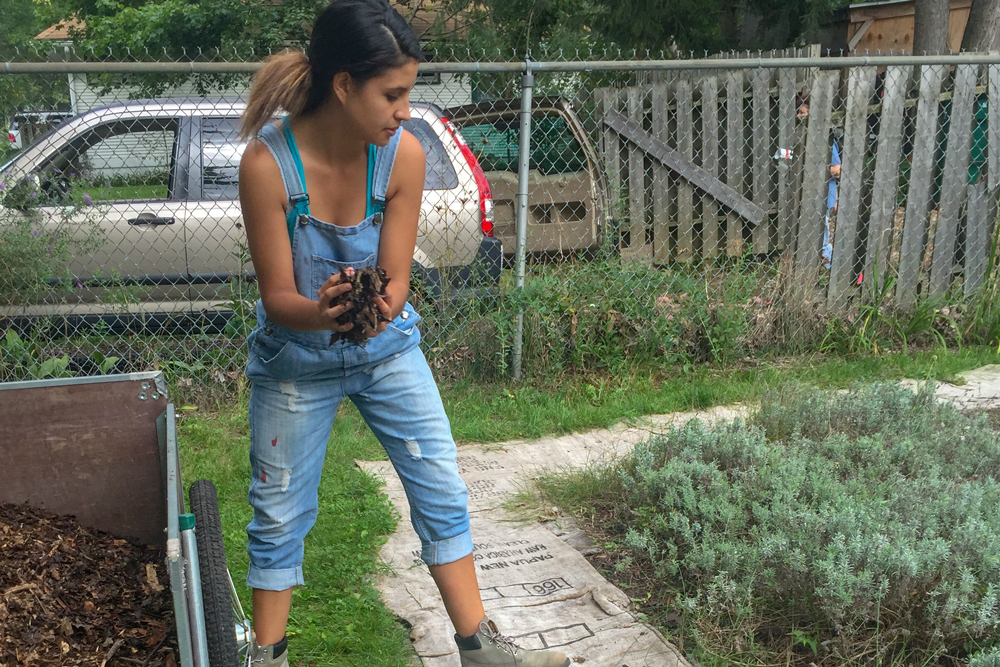 AFRE senior Alondra Alviso working in a garden