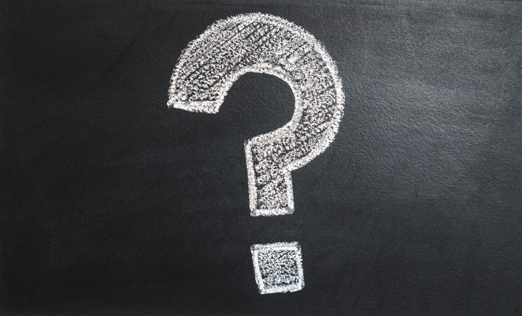 A white question mark on a black background.