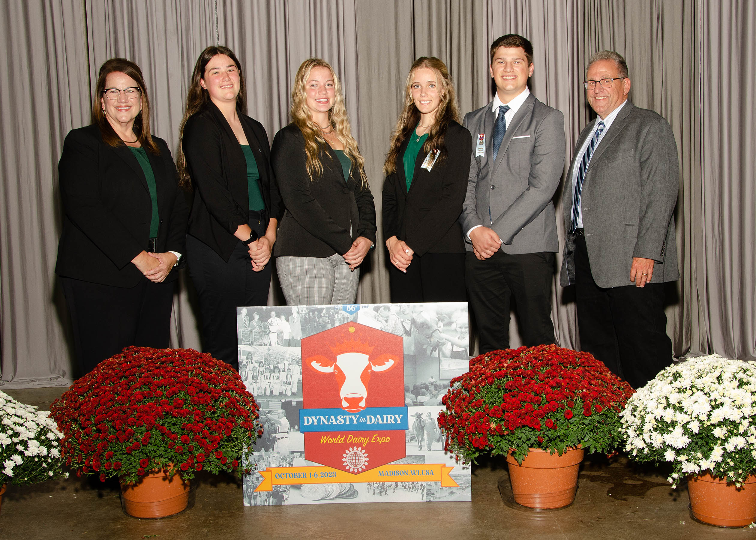 Team members in front of the backdrop.