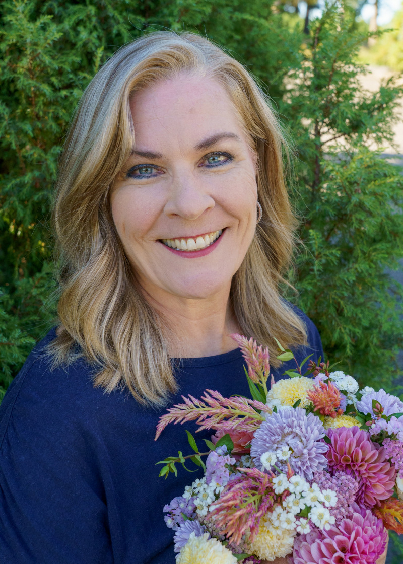 Charlotte Smith holding a cut flower arrangement.