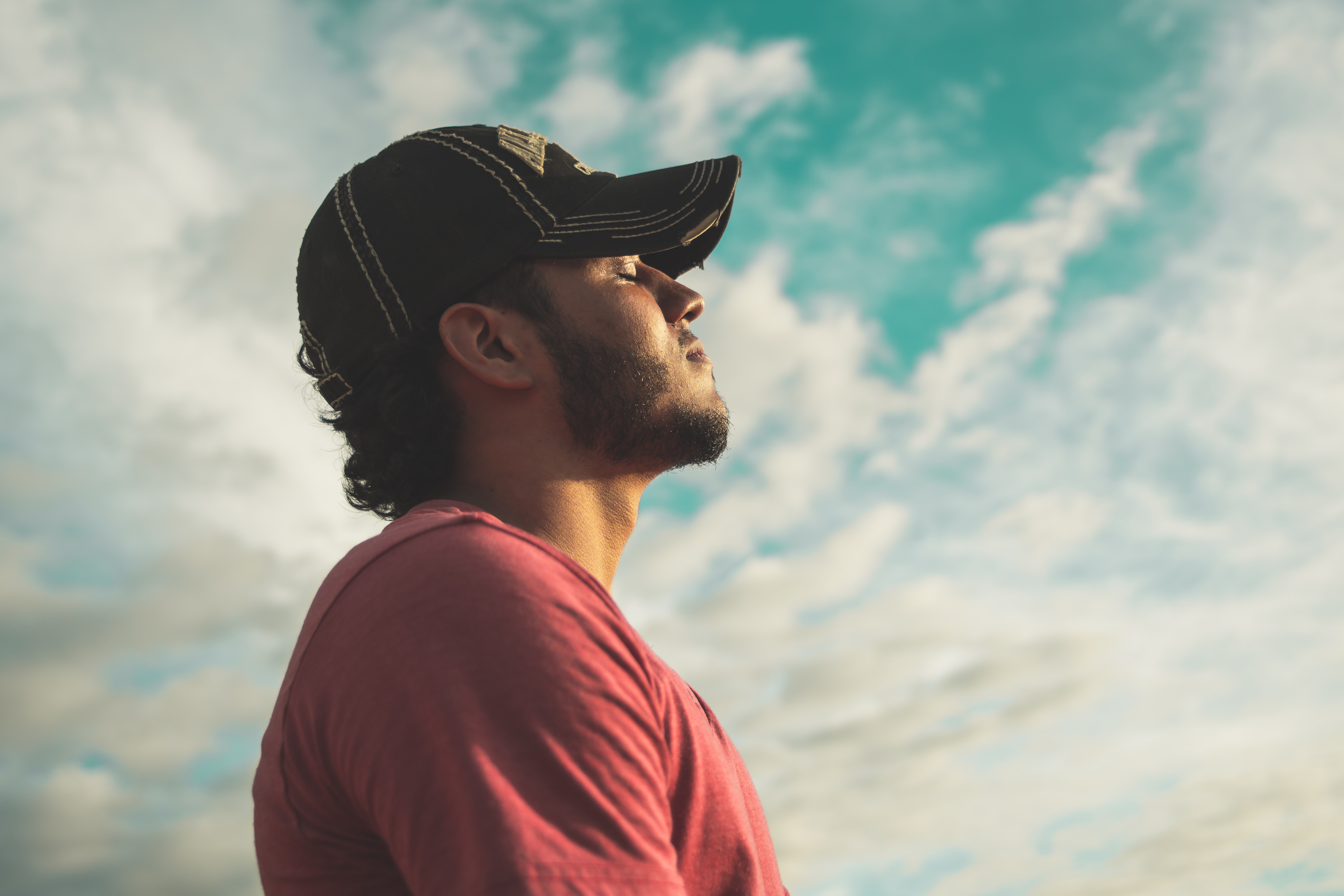 Picture of a man taking a deep breath outside.