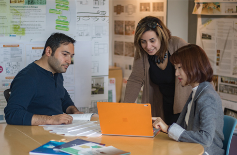 Environmental design graduate students meeting and discussing project ideas.