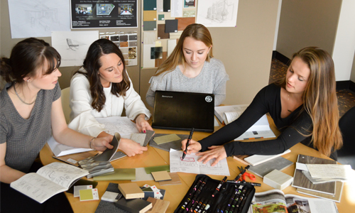 Four students meeting to discuss an interior design project.