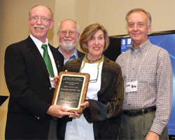 Paul Nieratko, Tony Bauer and Duane Mezga present Dr. Westphal with a recognition plaque at her retirement dinner.