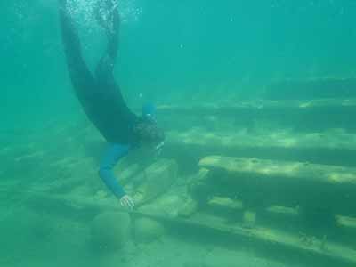 Camper snorkeling next to sunken ship